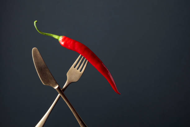 Hot chili red pepper on a fork. Spice concept. Copy space.