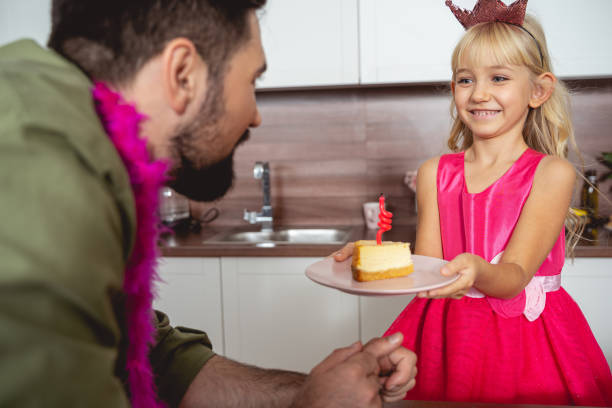 istock Young man celebrating birthday with his cute daughter 1194732211