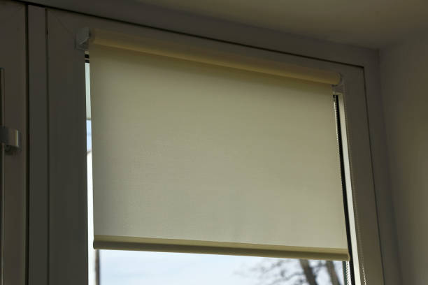 istock rolled textile blinds on a plastic window in a room, object of protection against sunlight close up. 1194733806