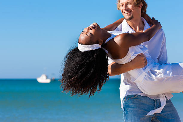 istock Man carrying his wife on beach 119473574