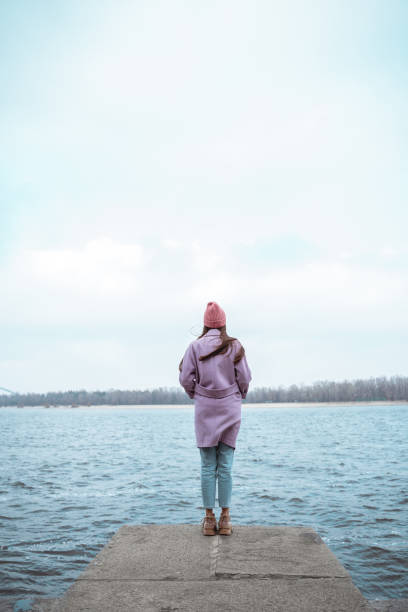 istock Thoughtful long haired female standing on the border 1194735906