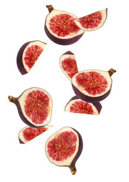 istock falling pieces of figs isolated on white background. 1194735983