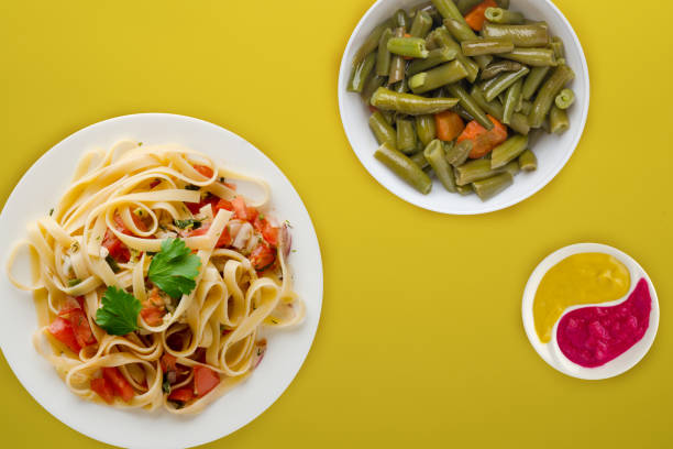 istock spaghetti on a white plate. spaghetti tomatoes, onions, cabbage on a colored background. healthy food 1194736316