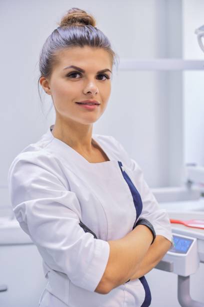 istock Young confident female dentist doctor with folded arms 1194736773