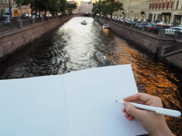 istock Mockup of person's hand holding blank white notebook preparing to write down his or hers ideas. 1194737545
