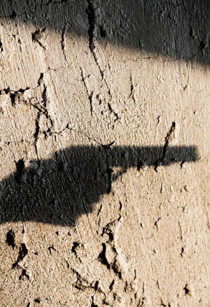 istock Shadow of the hand pointing a gun 1194738764