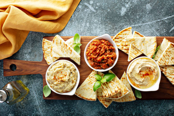Mezze board with pita and dips Mediterranean mezze board with pita and dips meze stock pictures, royalty-free photos & images