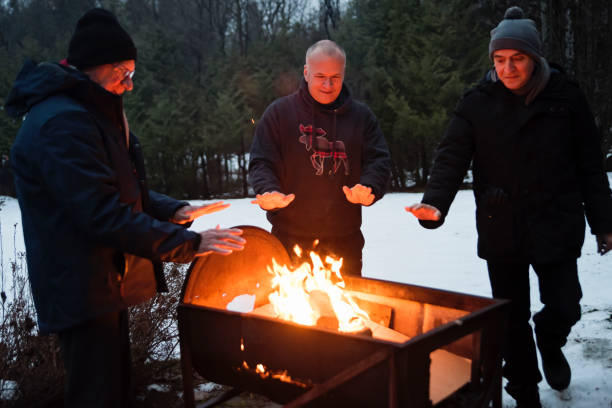 istock Senior and mature men beside a fire outdoors in winter 1194740398