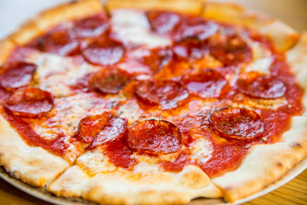 istock round pizza with sausage, cheese and spices 1194740472