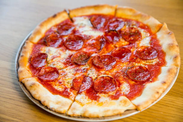 istock round pizza with sausage, cheese and spices 1194741003