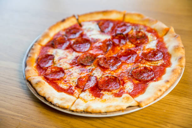 istock round pizza with sausage, cheese and spices 1194741124