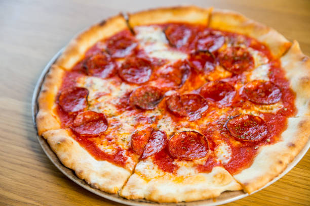 istock round pizza with sausage, cheese and spices 1194741154