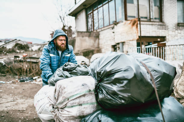 istock Homeless Male Pushing His Garbage Cart 1194741676
