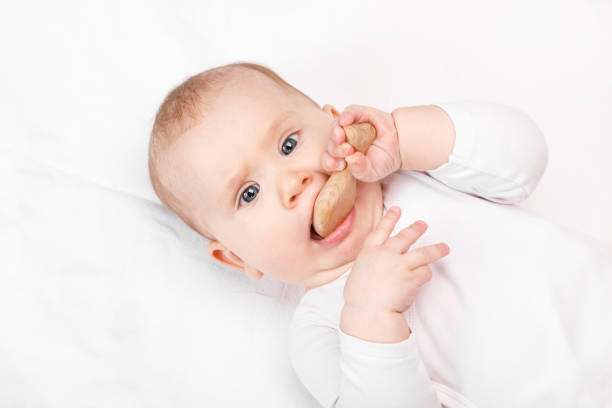 istock Little baby chews wooden teether 1194742381