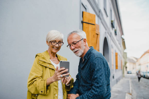istock Senior couple traveling and using smart phone 1194743559