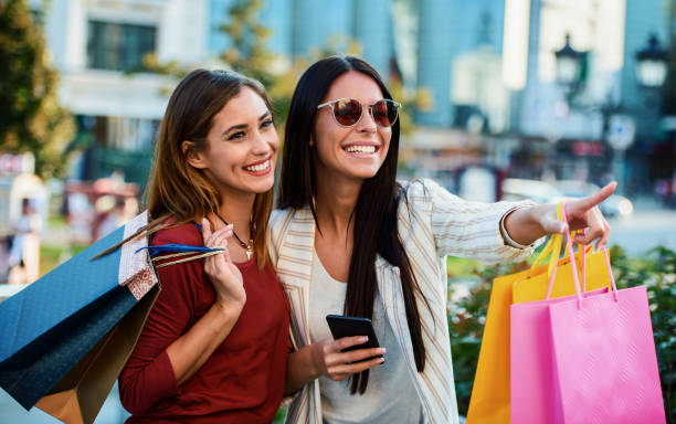 Shopping time. Young women shopping together. Consumerism, fashion, lifestyle stock photo
