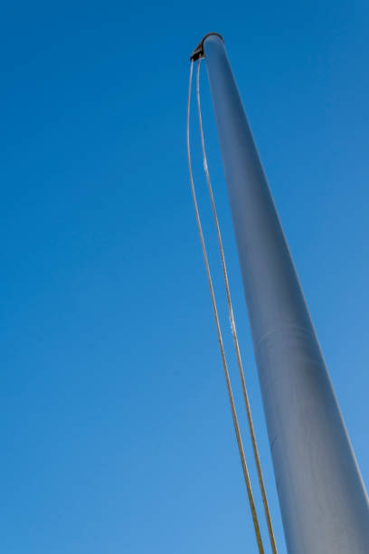 istock Flagpoles on a cold sunny winter day against a blue clear sky 1194744771