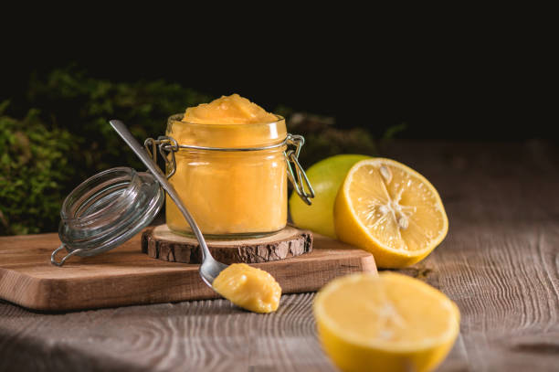 istock Lemon curd in glass jar with fresh lemons 1194745764