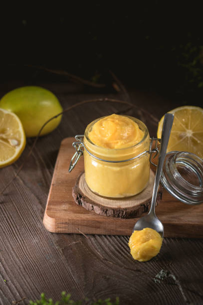 istock Lemon curd in glass jar with fresh lemons 1194745775