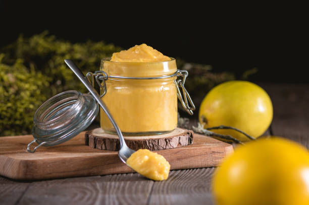 istock Lemon curd in glass jar with fresh lemons 1194745783