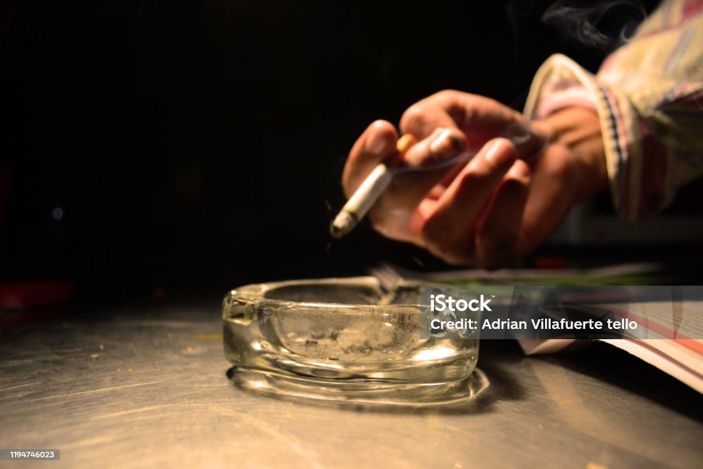 The cigarrete A hand holding cigarrete Addiction Stock Photo