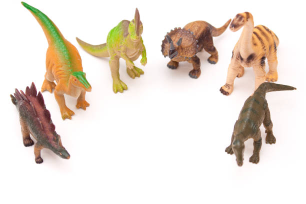 istock Group of toy plastic dinosaurs on the white background. 1194747050