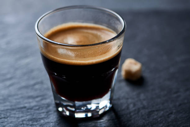 istock Coffee in glass cup on dark background. Close up. 1194747180
