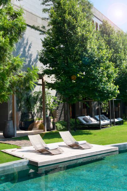 istock Deck chairs on Wooden plank floor against swimming pool 1194747970
