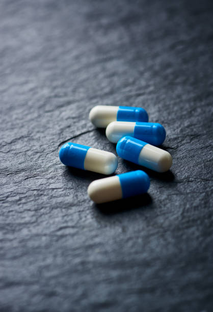 istock Sports Supplements (creatine capsules) on dark stone background. Close up. 1194749609