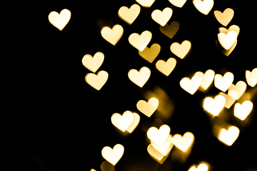 Festive overlay effect. Golden heart bokeh festive glitter background. Christmas, New Year and Valentine's day design