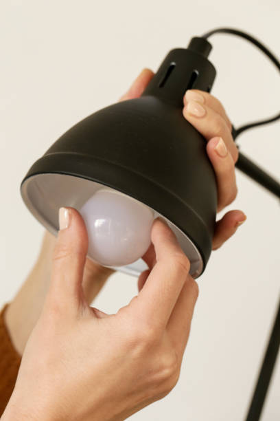 istock Replacing light bulb at home. Simple DIY housework maintaince. 1194754933