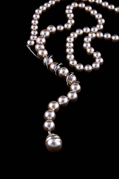 istock White pearls necklace on black 119475507