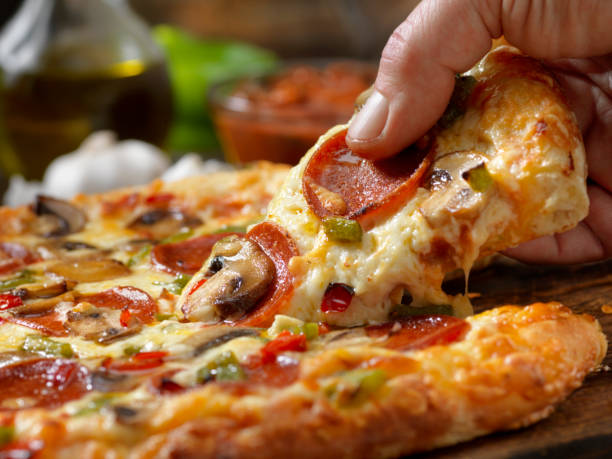 istock Taking the First Piece of Pizza 1194757068