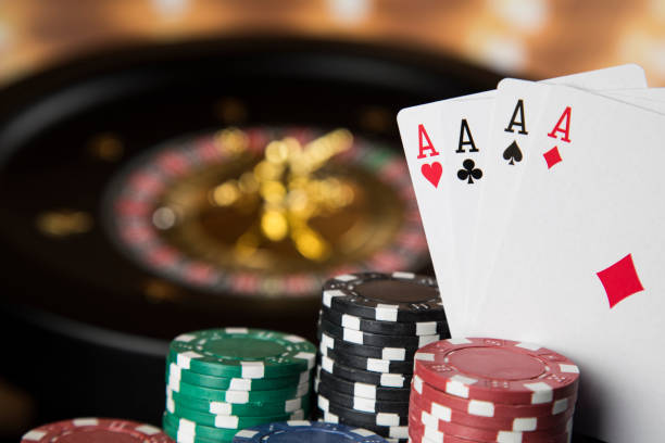 istock Poker Chips on gaming table, roulette wheel in motion, casino background 1194758301