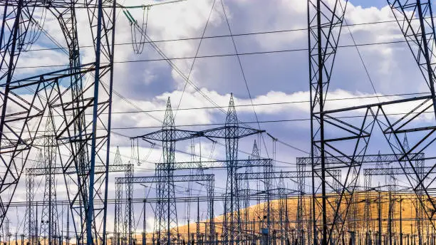 Photo of High voltage electricity towers and power lines at a substation in Central California; a substation is a part of an electrical generation, transmission, and distribution system