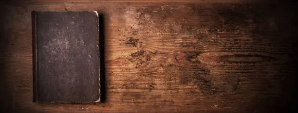 Old book on an old wooden board