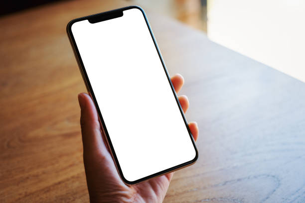istock a hand holding a black mobile phone with blank white desktop screen 1194779149