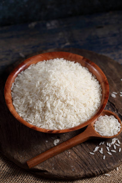 istock Close up white rice in measuring cup on table, Thai Jasmine rice in rustic kitchen background 1194781939
