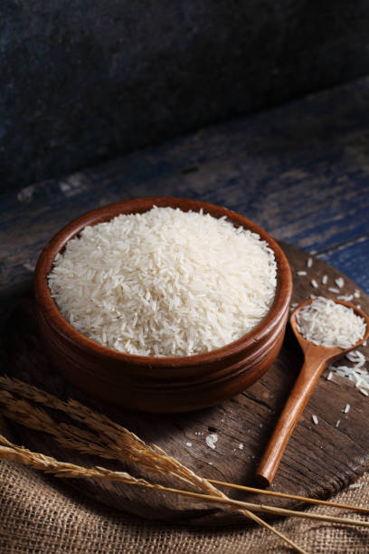 istock Close up white rice in measuring cup on table, Thai Jasmine rice in rustic kitchen background 1194781951