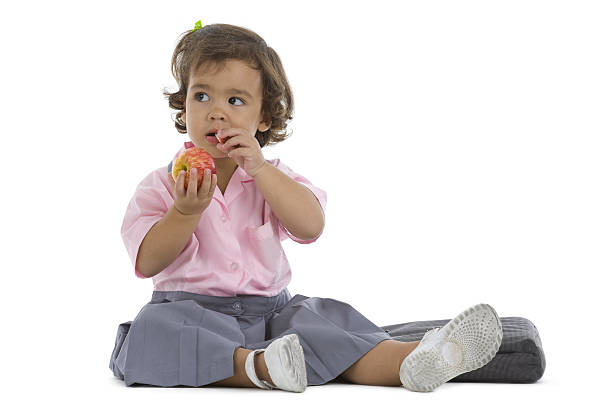 istock cute little girl with an apple 119478312