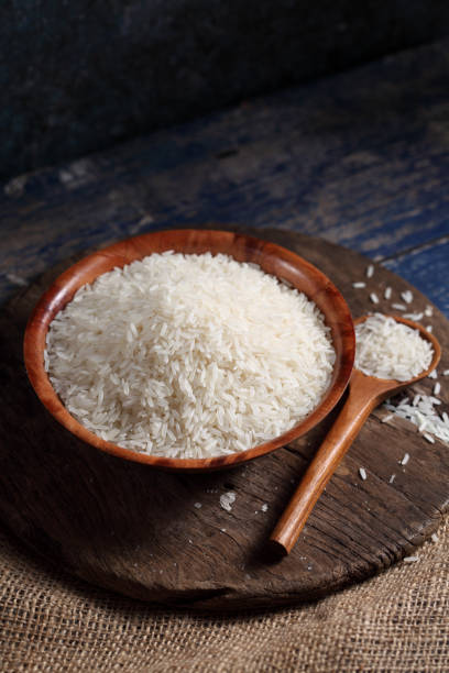 istock Close up white rice in measuring cup on table, Thai Jasmine rice in rustic kitchen background 1194784627