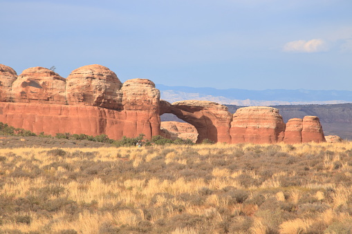 The broken arch formation can be seen across the desert at Arches National Park near Moab, Utah
