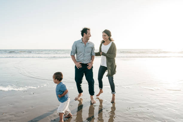 istock Parents playing with kids on the beach 1194787994