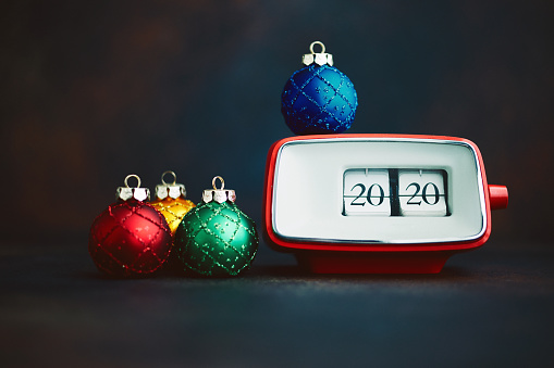 Vintage clock showing 2020 with holiday decorations. New Year 2020