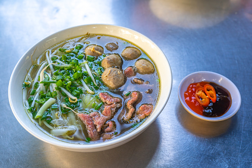 Tasty Vietnamese Pho bowl- beef meat noodles soup on table