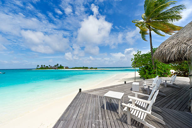 istock chairs on wooden deck towards the sea 119479167