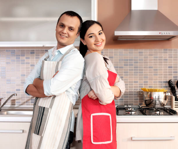 istock Young couple cooking in kitchen 1194798847