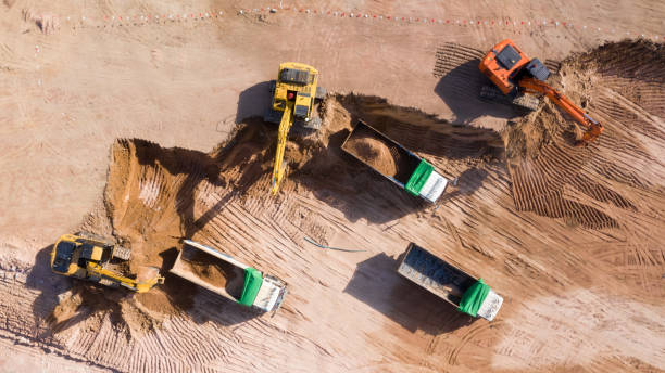 istock Aerial view group of excavator and dump truck working on a construction site, Construction site view from above. 1194799536