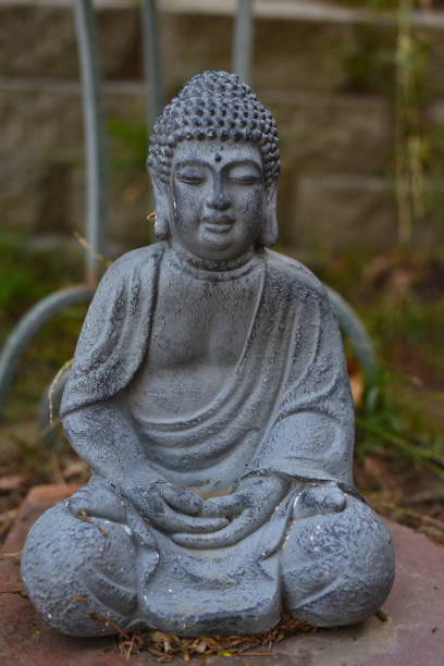 istock Close up of a gray stone Buddha statue 1194799733