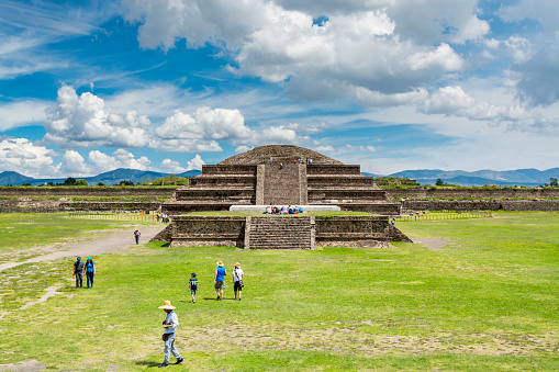 Ruins of the architecturally significant Mesoamerican pyramids and green grassland located at at Teotihuacan, an ancient Mesoamerican city located in a sub-valley of the Valley of Mexico